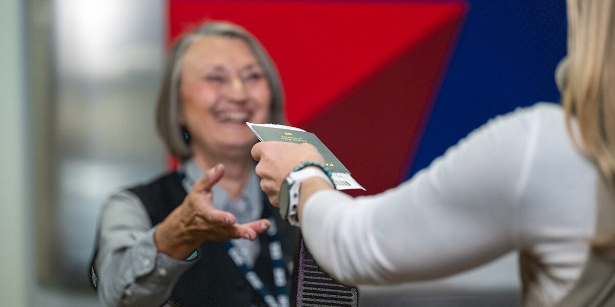 Handing information to woman behind counter